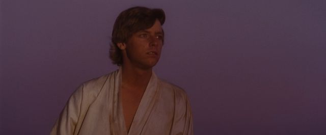 Luke looks to the two setting suns of Tatooine